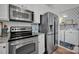 Stainless steel appliances and granite countertops in this well-equipped kitchen at 156 Singleton Rd, Mooresville, NC 28117