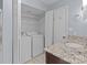 Bathroom featuring washer and dryer, single sink vanity and granite countertops at 17931 Kings Point Dr # G, Cornelius, NC 28031