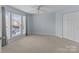 Light-filled bedroom boasts a ceiling fan, closet, and large window with natural light at 17931 Kings Point Dr # G, Cornelius, NC 28031