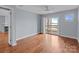 Bright bedroom featuring hardwood floors and sliding glass doors to a private balcony with water views at 17931 Kings Point Dr # G, Cornelius, NC 28031