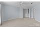 Bedroom features a ceiling fan, closet, and large window with natural light at 17931 Kings Point Dr # G, Cornelius, NC 28031