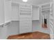 Walk-in closet with shelving and mirror; wood floor at 17931 Kings Point Dr # G, Cornelius, NC 28031