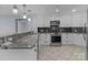 Modern kitchen features granite countertops, stainless steel appliances, and ample cabinet space at 17931 Kings Point Dr # G, Cornelius, NC 28031