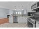 Updated kitchen with granite countertops, stainless steel appliances, and a view to living area at 17931 Kings Point Dr # G, Cornelius, NC 28031