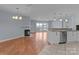 Open-concept living area with hardwood floors, fireplace, and scenic lake views from the window at 17931 Kings Point Dr # G, Cornelius, NC 28031