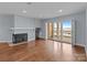 Cozy living room features a fireplace and access to the balcony with lake views at 17931 Kings Point Dr # G, Cornelius, NC 28031