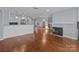 Bright, open living space with hardwood floors, a fireplace, and a glimpse of the kitchen at 17931 Kings Point Dr # G, Cornelius, NC 28031