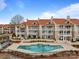 Stunning exterior view of building and pool; luxurious condos with a waterfront view at 17931 Kings Point Dr # G, Cornelius, NC 28031