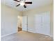 Spacious bedroom with ceiling fan and access to hallway at 1903 46Th Avenue Ne Dr, Hickory, NC 28601