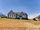 Gray house with a white front porch sits on a grassy lot at 1903 46Th Avenue Ne Dr, Hickory, NC 28601