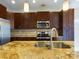 Modern kitchen with granite countertops, stainless steel appliances, and dark wood cabinets at 1903 46Th Avenue Ne Dr, Hickory, NC 28601