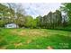 Large backyard with a chain link fence and mature trees at 2085 Faith Rd, Salisbury, NC 28146