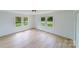 Bright bedroom with light wood flooring and two large windows at 2085 Faith Rd, Salisbury, NC 28146
