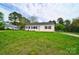 Front view of a charming white house with a green door and a large grassy yard at 2085 Faith Rd, Salisbury, NC 28146