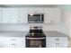 Stainless steel appliances and granite countertops shine in this updated kitchen at 2085 Faith Rd, Salisbury, NC 28146