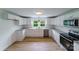 Newly renovated kitchen, featuring white shaker cabinets, granite countertops, and stainless steel appliances at 2085 Faith Rd, Salisbury, NC 28146