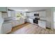 Modern kitchen with white cabinets, granite countertops, and stainless steel appliances at 2085 Faith Rd, Salisbury, NC 28146