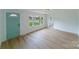 Bright and airy living room with light wood floors and a green door at 2085 Faith Rd, Salisbury, NC 28146