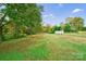 Large grassy backyard with mature trees and shed at 2500 S Ridge Ave, Kannapolis, NC 28083