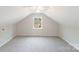 Charming attic bedroom with window and ceiling fan at 2500 S Ridge Ave, Kannapolis, NC 28083