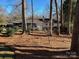 Ranch home with mature trees and pine straw landscaping at 279 Beverly Ne Dr, Concord, NC 28025