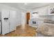 White kitchen with granite countertops and modern appliances at 2816 Wedgefield Dr, Charlotte, NC 28208