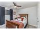 Cozy bedroom featuring a wooden bed frame, ceiling fan, and natural light from the window at 421 N Church St # 12F, Charlotte, NC 28202