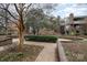 Exterior shot of a brick courtyard featuring mature shade trees and walking path at 421 N Church St # 12F, Charlotte, NC 28202