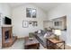 Spacious living room featuring a charming brick fireplace, creating a cozy and inviting atmosphere at 421 N Church St # 12F, Charlotte, NC 28202