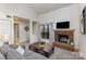 Bright living room with a cozy brick fireplace and large window, creating a warm and inviting space at 421 N Church St # 12F, Charlotte, NC 28202