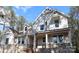Beautiful two-story home featuring stone accents, dormer windows, and a covered front porch with large support columns at 5053 Townsend Rd, Lancaster, SC 29720
