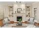 Living room with built-in shelving and a fireplace at 7013 Willow Trace Ln, Weddington, NC 28104