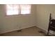 Small bedroom with floral wallpaper, carpeted floor, and a window with sheer curtains at 744 N Little Egypt Rd, Denver, NC 28037