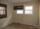 Bedroom featuring neutral wallpaper, carpeted floors and two large windows at 744 N Little Egypt Rd, Denver, NC 28037