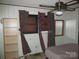Bedroom with wood-paneled walls, window with patterned curtains, and ceiling fan at 744 N Little Egypt Rd, Denver, NC 28037
