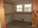 Walk-in closet with wood shelving and double windows offering natural light at 744 N Little Egypt Rd, Denver, NC 28037