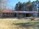 Brick ranch home with red metal roof, detached garage, and large yard at 744 N Little Egypt Rd, Denver, NC 28037