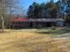 Ranch-style home with red metal roof, brick facade, and a spacious yard at 744 N Little Egypt Rd, Denver, NC 28037