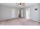 Well-lit bedroom with ceiling fan, carpet, and access to bathroom and closet at 842 Wilcrest Ct, York, SC 29745