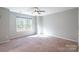 Spacious bedroom with neutral walls, carpeting, and a large window at 842 Wilcrest Ct, York, SC 29745