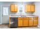 Bright kitchen, featuring wood cabinets, stainless steel dishwasher, and a door to outside at 842 Wilcrest Ct, York, SC 29745