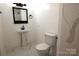 Updated bathroom with pedestal sink, toilet and marble floor at 9 N 11Th Ave, Maiden, NC 28650