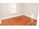 Well-lit bedroom with hardwood floors and window at 9 N 11Th Ave, Maiden, NC 28650