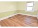 Spacious bedroom with hardwood floors and window at 9 N 11Th Ave, Maiden, NC 28650