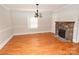 Bright dining room features hardwood floors, a stone fireplace, and a charming chandelier at 9 N 11Th Ave, Maiden, NC 28650