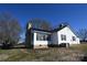 White house with stone accents, a metal roof, and a spacious yard at 9 N 11Th Ave, Maiden, NC 28650