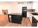Kitchen with white cabinets, black appliances, and an island at 9 N 11Th Ave, Maiden, NC 28650
