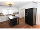 Kitchen with white cabinets, black appliances, and an island at 9 N 11Th Ave, Maiden, NC 28650