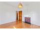 Bright bedroom with hardwood floors, fireplace, and door to hallway at 956 Stony Point Rd, Kings Mountain, NC 28086