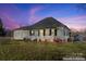 White house with porch and attached garage at dusk at 956 Stony Point Rd, Kings Mountain, NC 28086